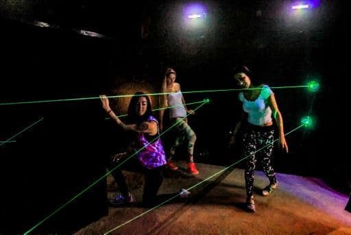 Women navigating laser maze beams at Wild Fun Zone